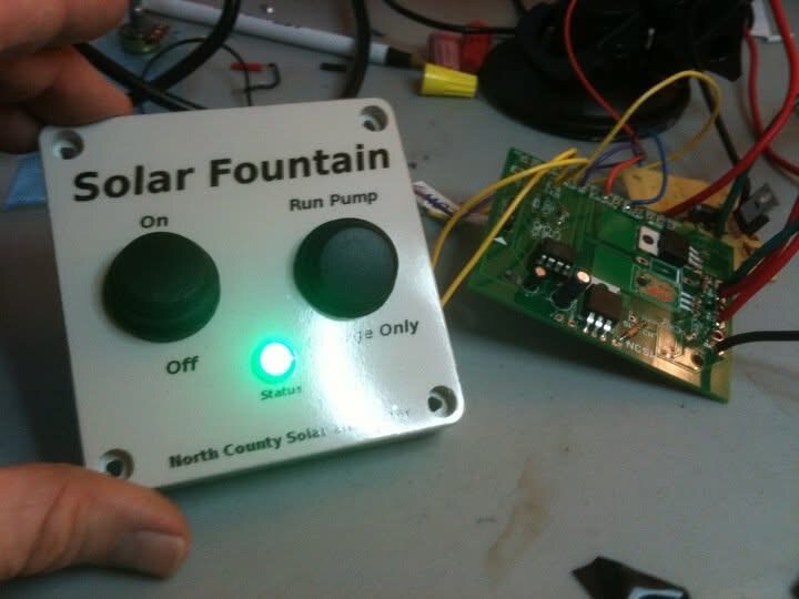 Solar controller lid and board on electronics bench